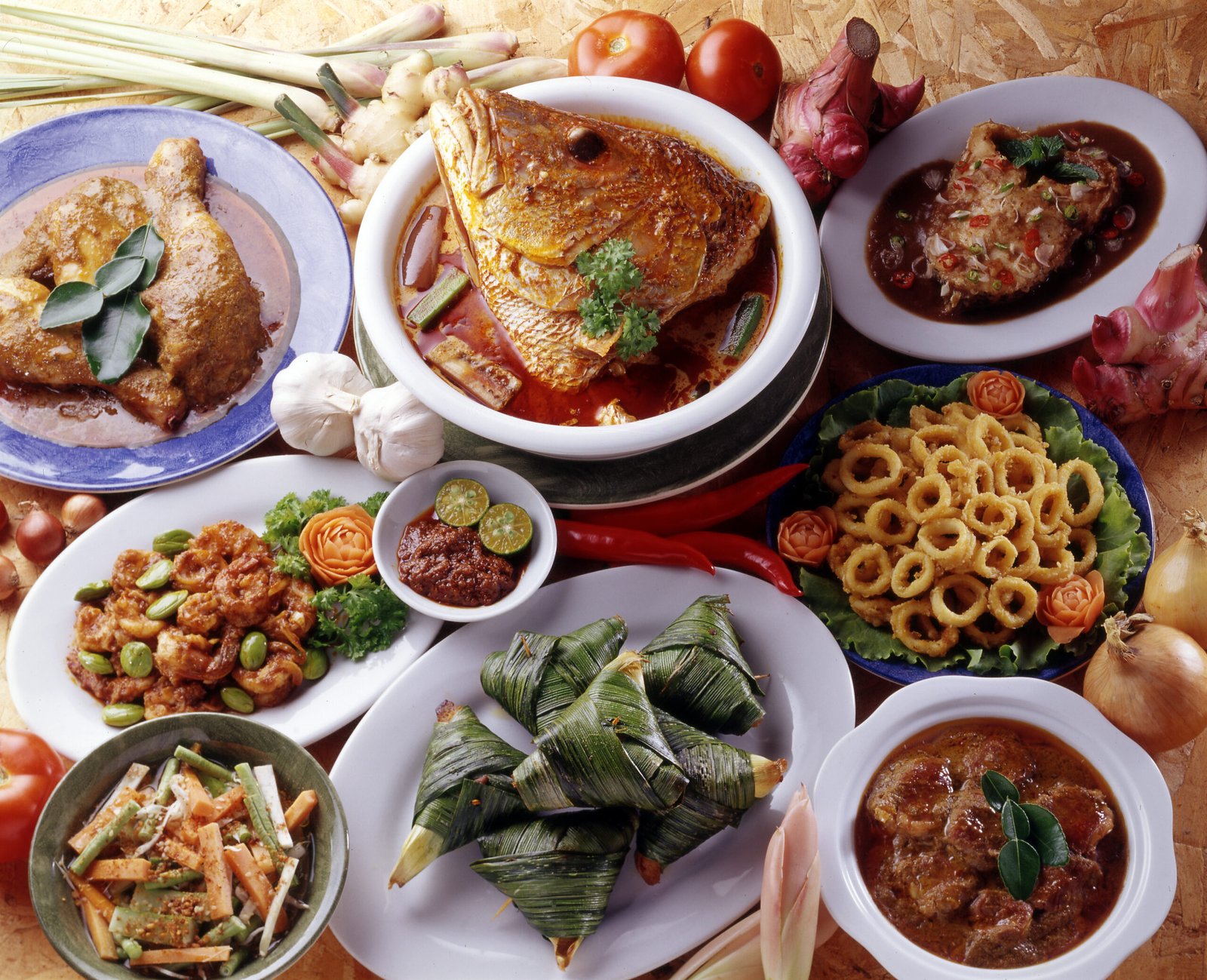 A table of Nyonya dishes including kari kepala ikan, sotong goreng and rempah udang
